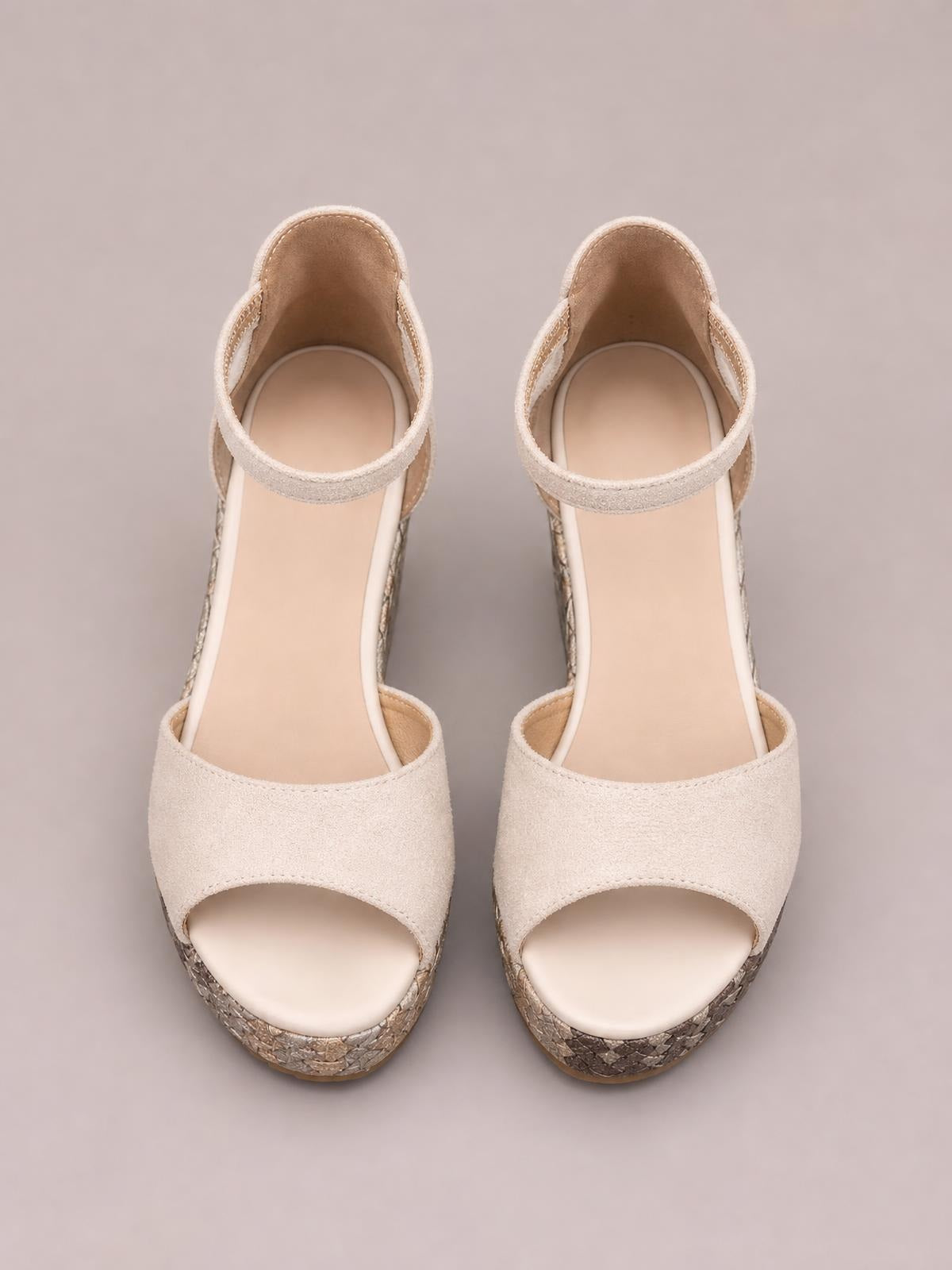 Cream cutout wedge platform sandals with peep toes, wide front straps, ankle straps, and textured high wedge soles in a neutral finish.