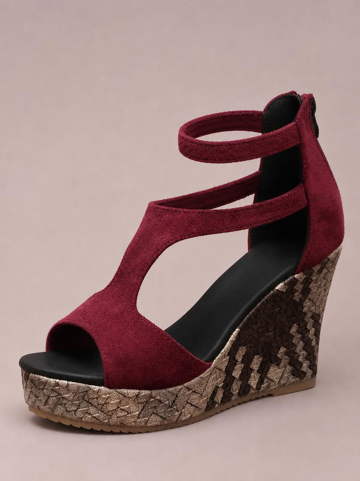 Burgundy cutout wedge platform sandal with an open toe, ankle strap, high wedge heel, and textured metallic patterned platform sole.