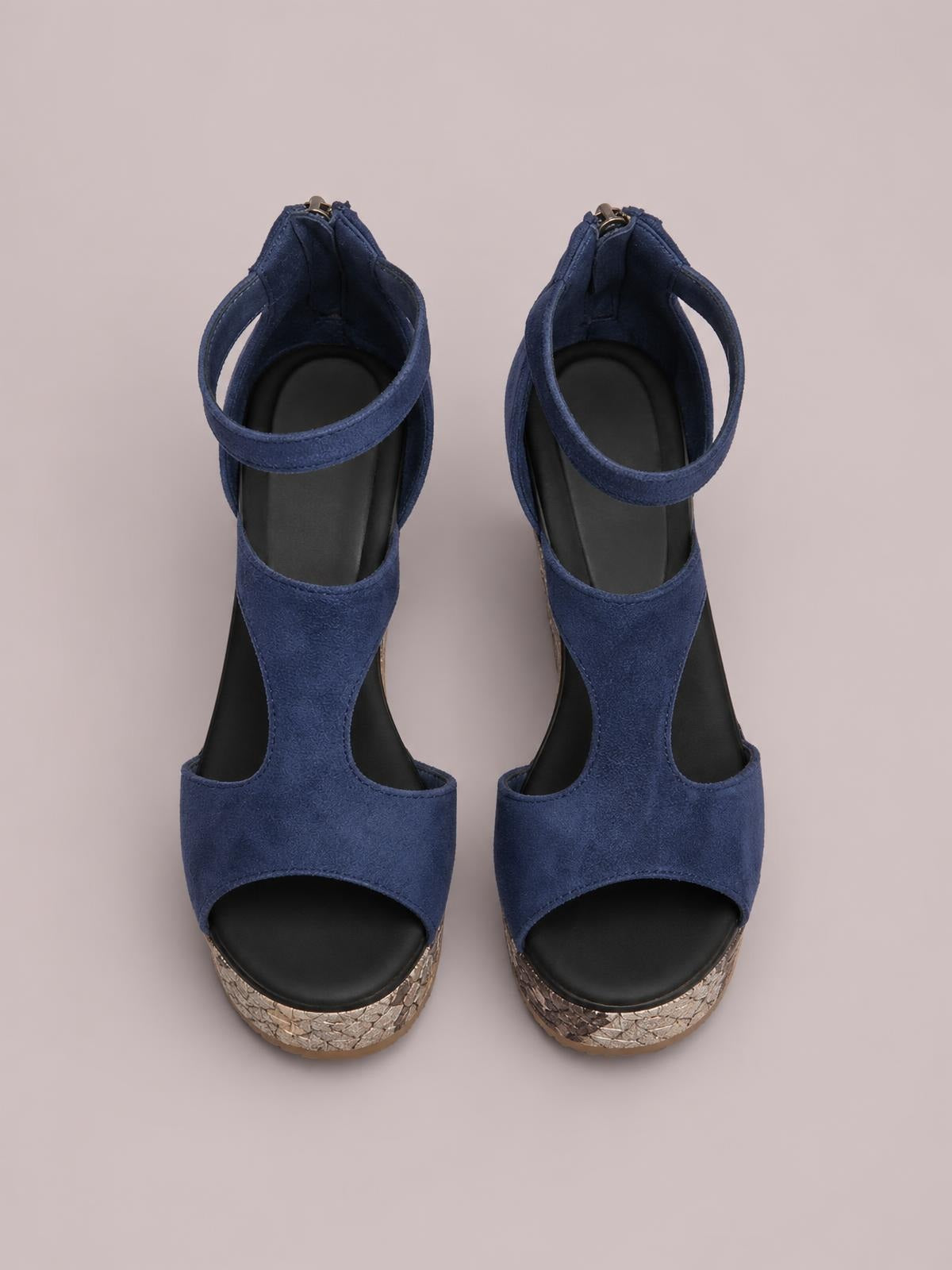 Navy blue cutout wedge platform sandals feature peep toes, wide front straps, ankle straps with buckles, and textured metallic wedge soles.