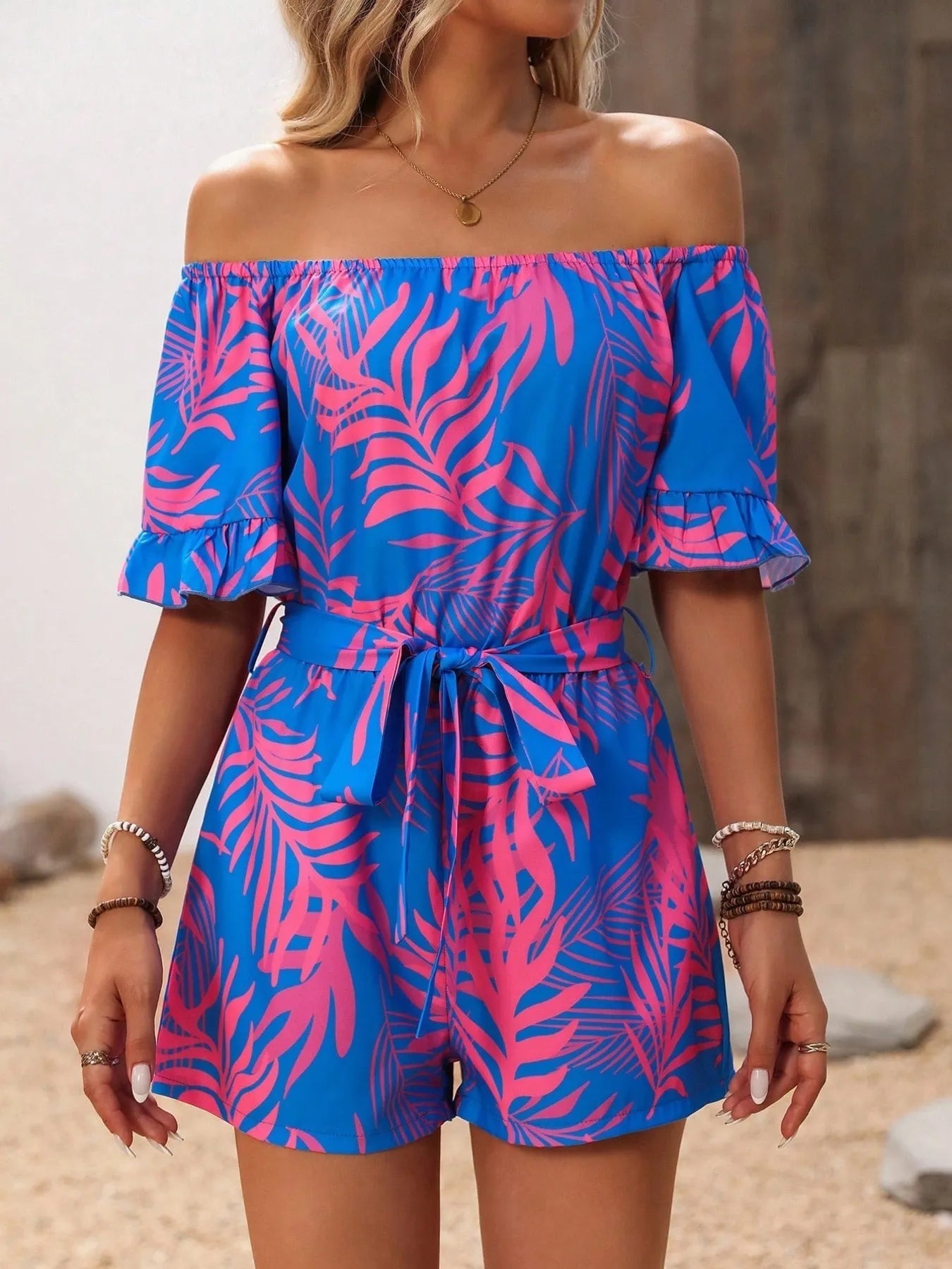Tropical Print Off-Shoulder Romper with Tie and Ruffles.