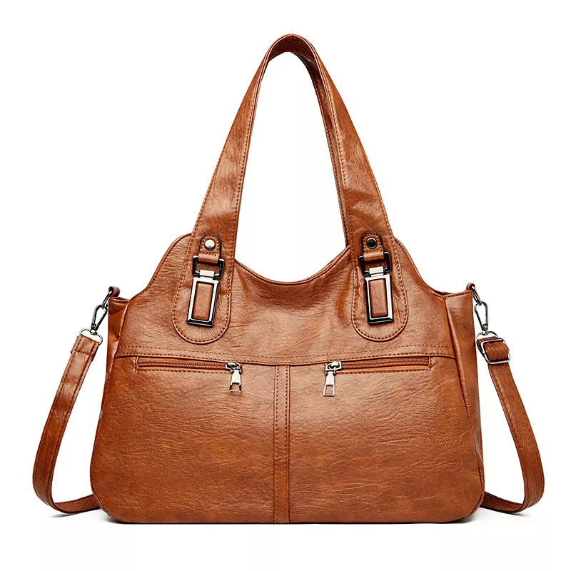 Large vintage-style brown PU leather handbag with dual top handles, a spacious structured silhouette, front zip pockets, and an adjustable shoulder strap.