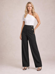Model poses in black high-rise pants with a wide-leg silhouette, smooth construction, and decorative gold buttons along the side waist.