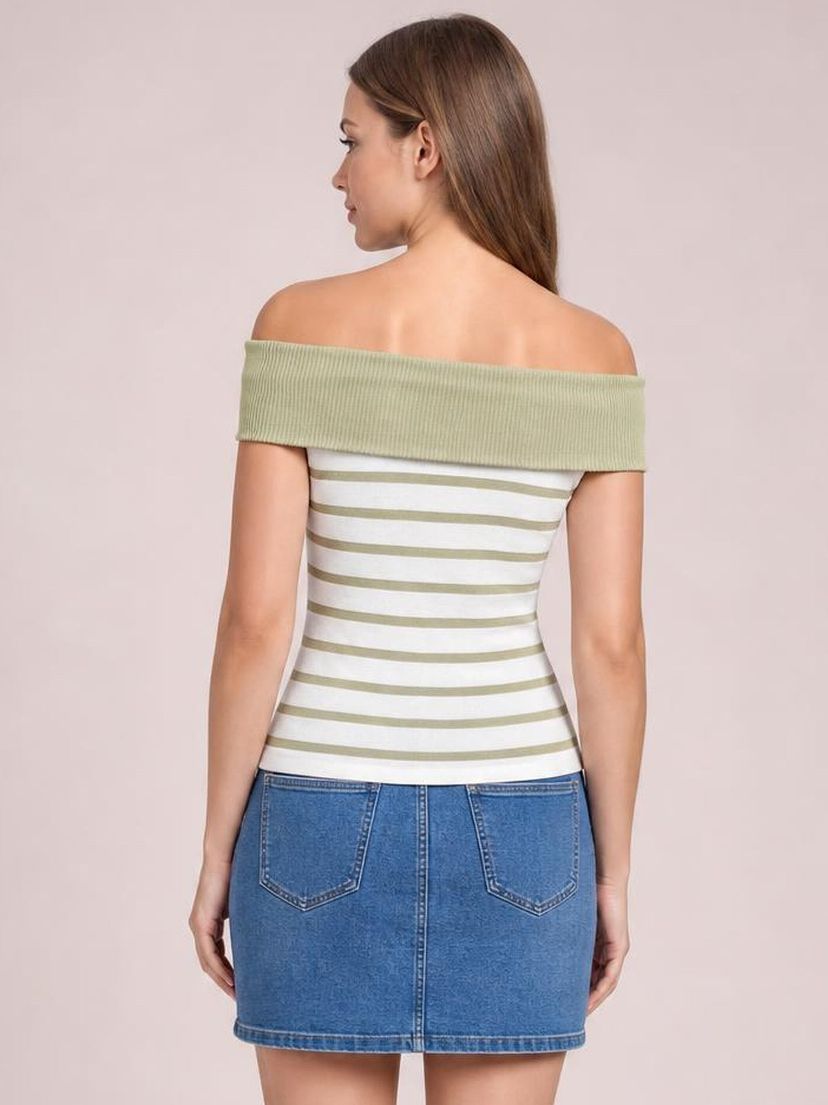 Model shown from behind wearing a fitted striped knit top with white and sage-green horizontal stripes and a wide off-shoulder neckline.