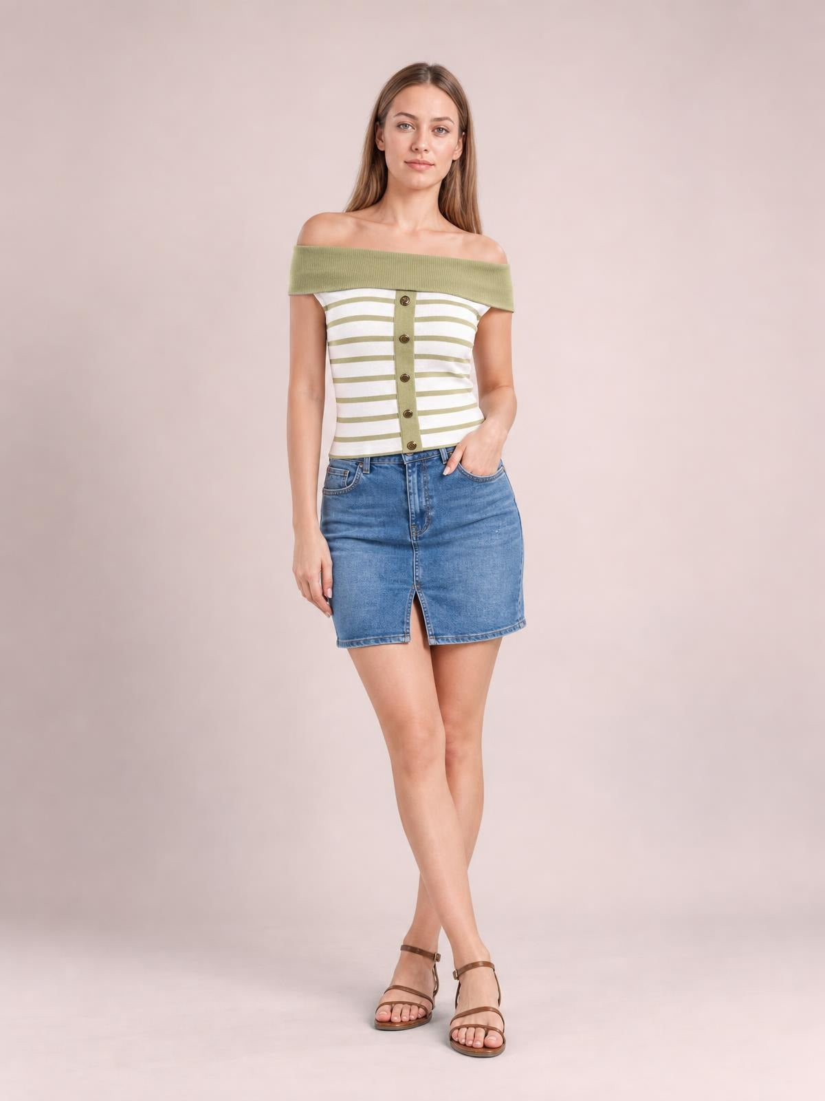 Model wears a sage green and white striped off-shoulder knit top with a fitted silhouette, wide neckline, and decorative front buttons.