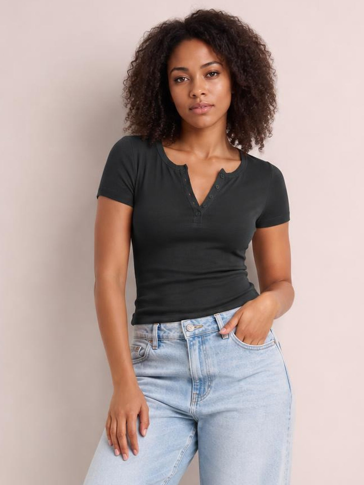 Model wearing a fitted charcoal Button Detail Short Sleeve T-Shirt with a notched neckline and visible button placket, paired with light-wash jeans.