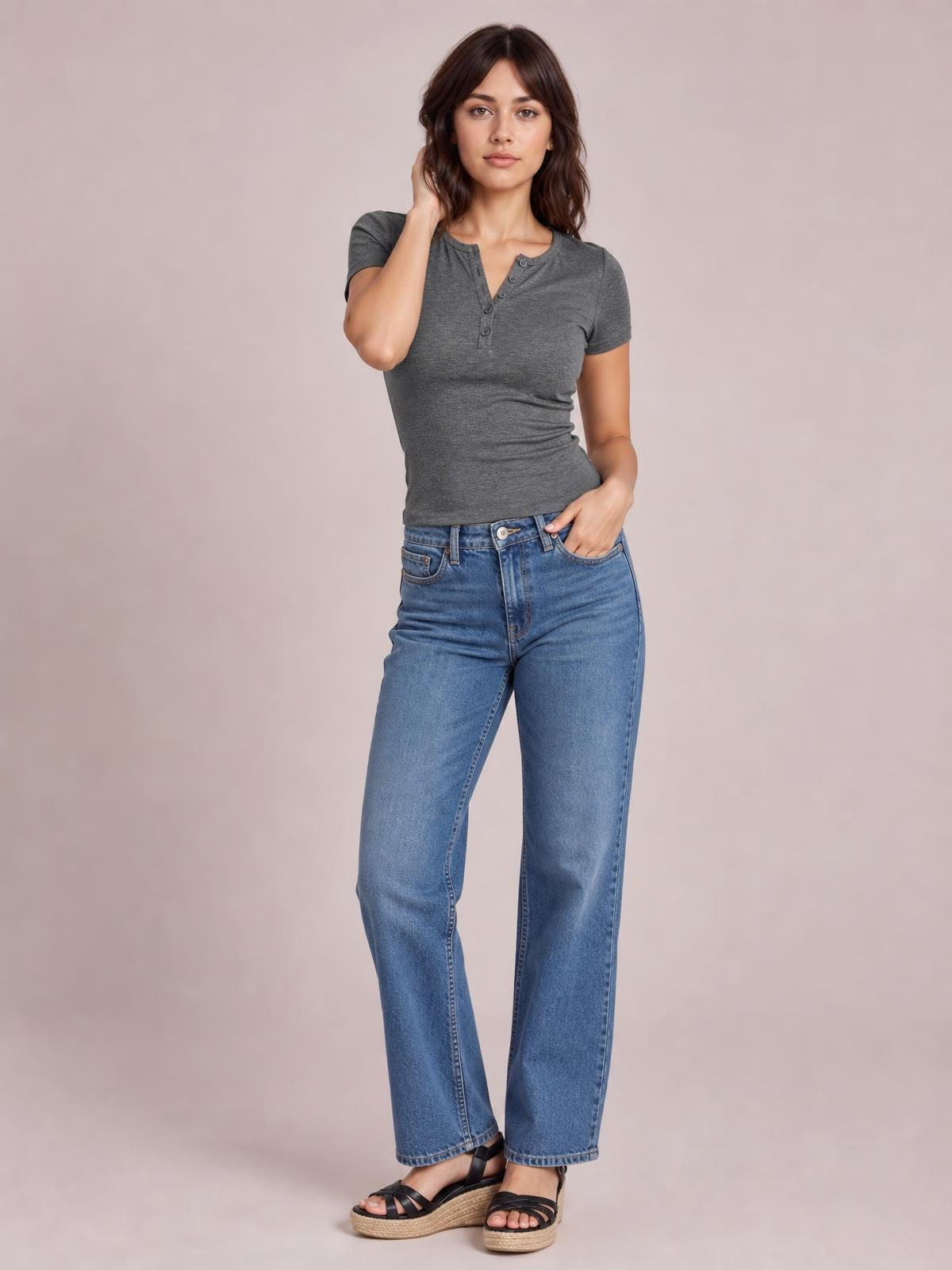 A model poses in a charcoal gray short-sleeve T-shirt with a fitted silhouette, stretch fabric, and button detail at the henley neckline.