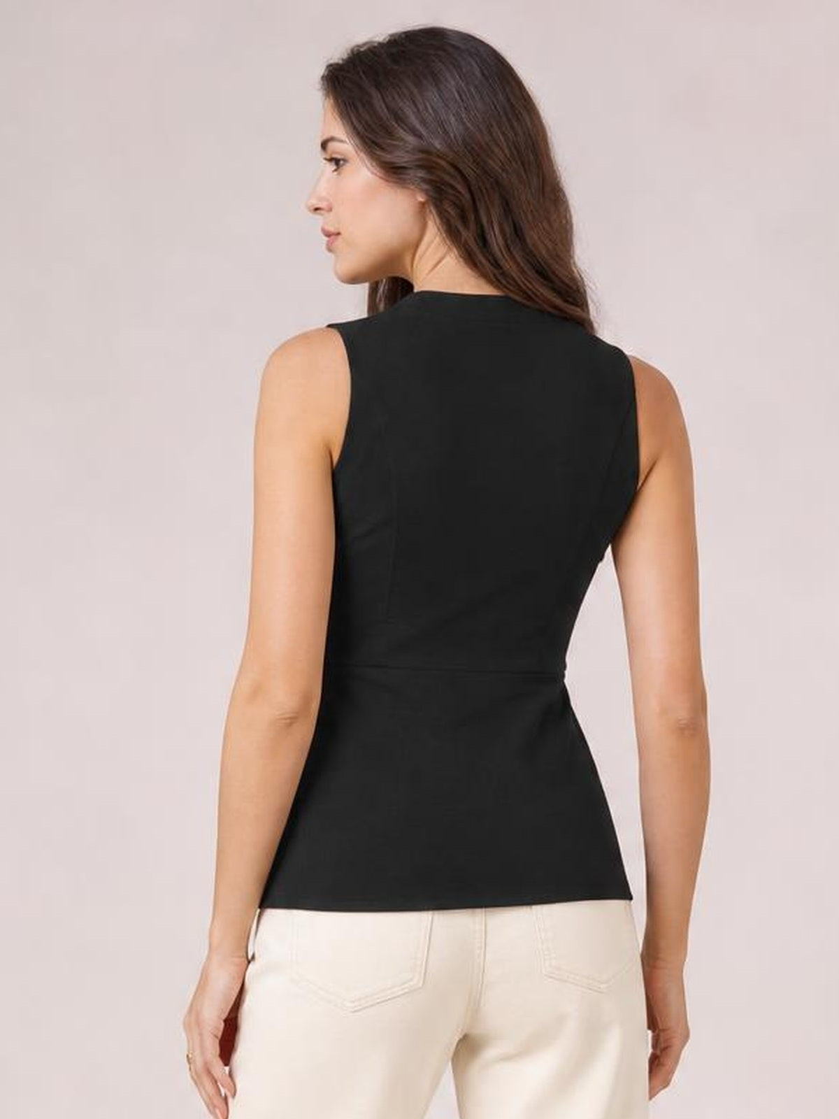 Model shown from the back in a black sleeveless button-down top with a fitted silhouette, clean seams, and a straight hem.