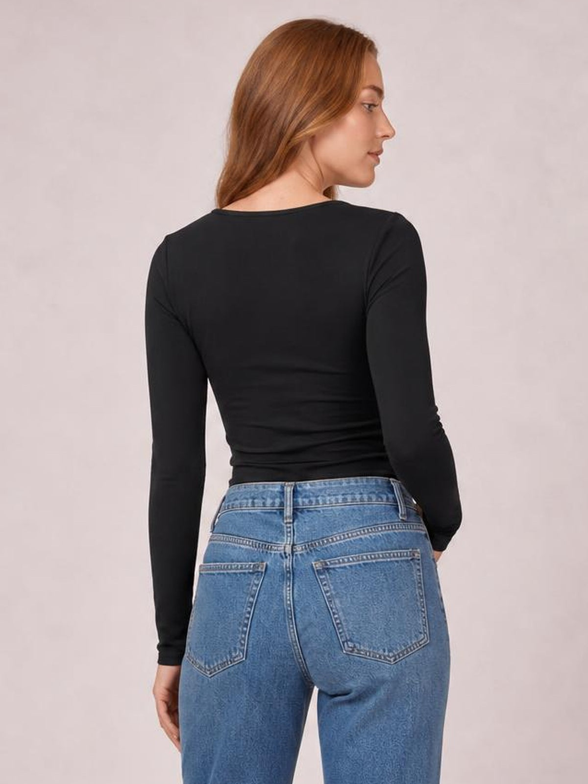 A model shown from behind wears a black Leopard Star long sleeve T-shirt with a rounded neckline, fitted silhouette, and softly gathered stretch fabric.