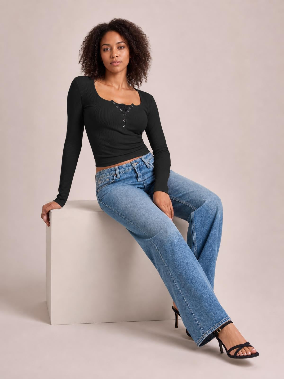 A model sits in a fitted black square-neck half-snap long-sleeve T-shirt with a ribbed finish, button placket, and slim silhouette.