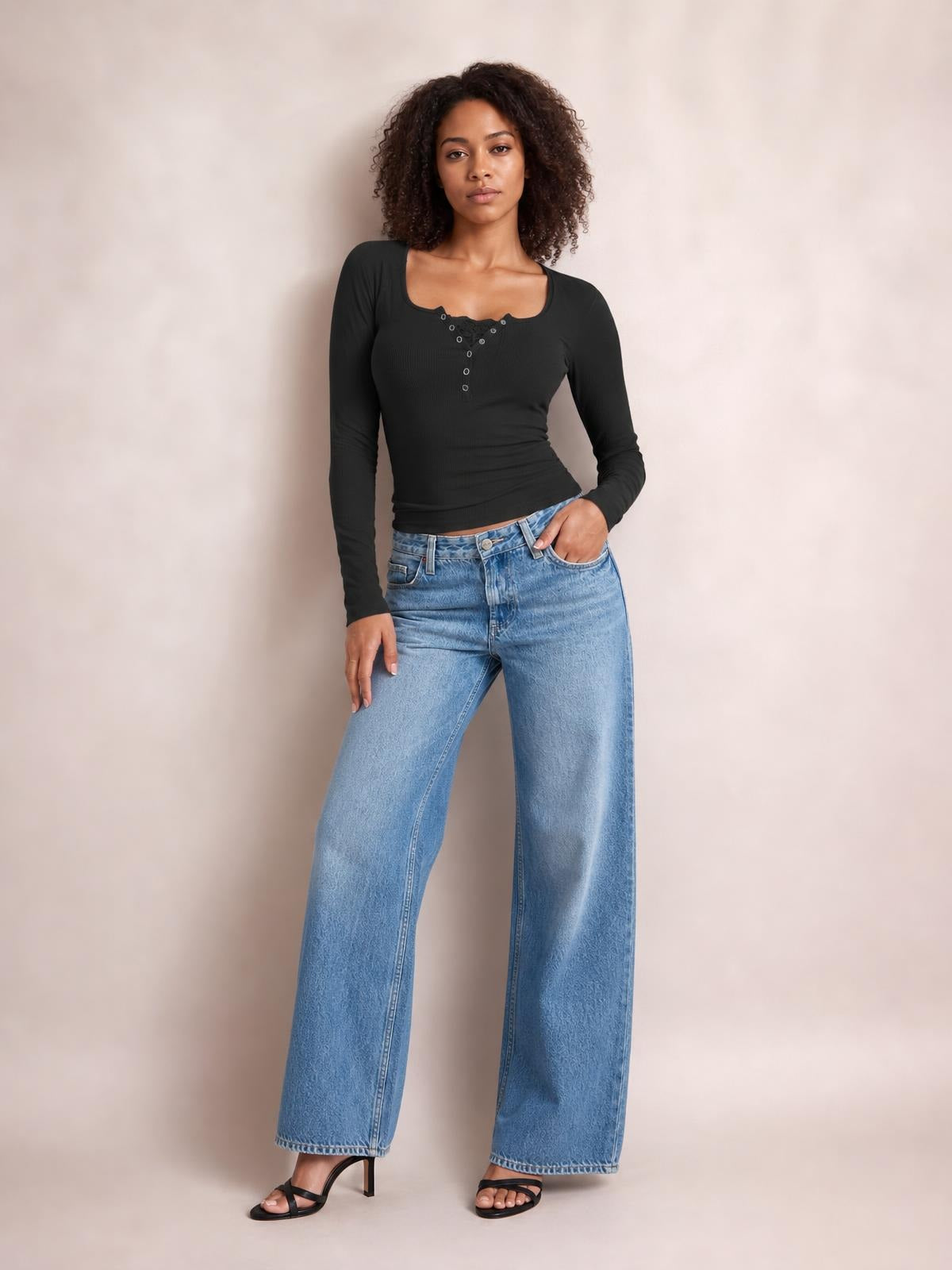 Model poses in a fitted black square-neck long-sleeve T-shirt with a half snap button placket and stretchy silhouette.