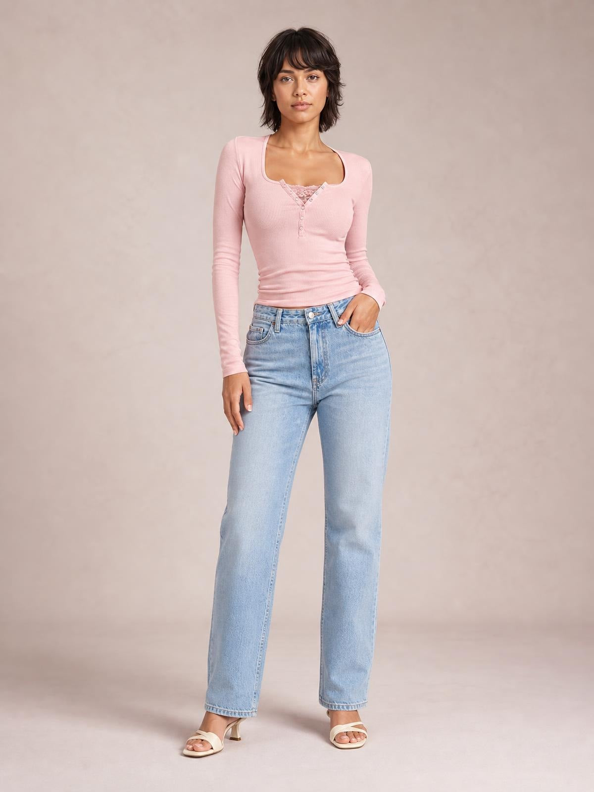 Model poses in a fitted pink ribbed long sleeve T-shirt with a square neckline, half-snap button placket, and stretchy slim silhouette.