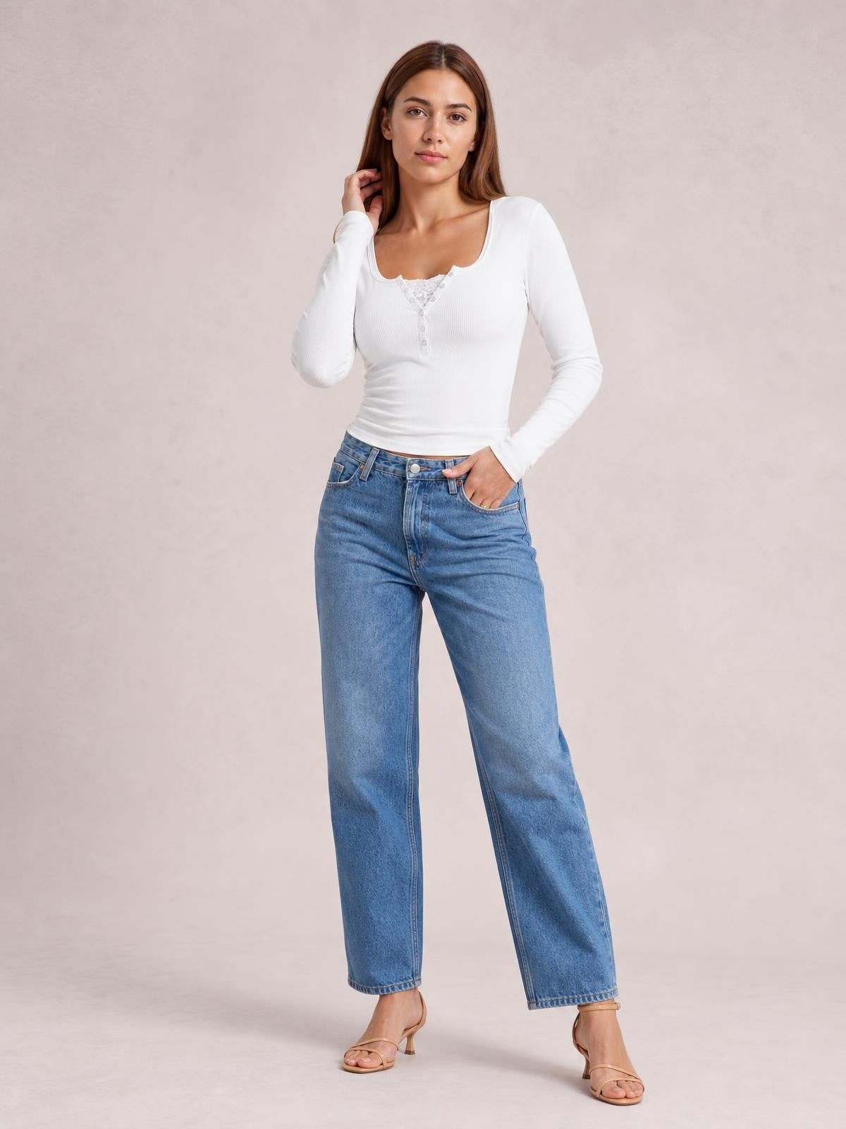 A model poses in a white square-neck half-snap long-sleeve T-shirt with a fitted ribbed silhouette and buttoned front.
