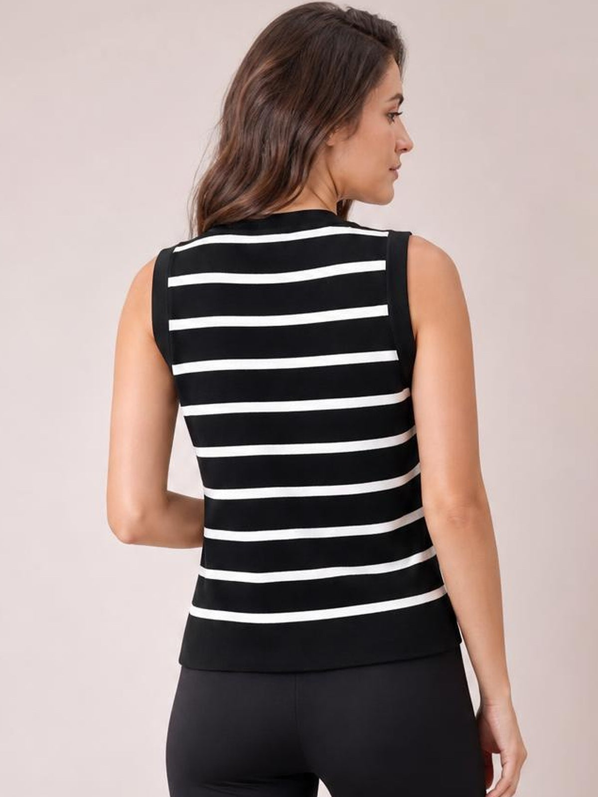 Model shown from the back in a black-and-white striped knit tank with a sleeveless cut, straight silhouette, and horizontal stripe construction.