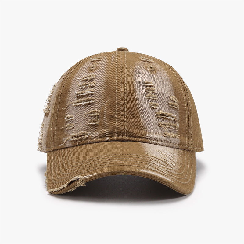 Distressed tan cotton baseball cap with a classic six-panel crown, gently curved brim, tonal stitching, and frayed details across the crown and brim.