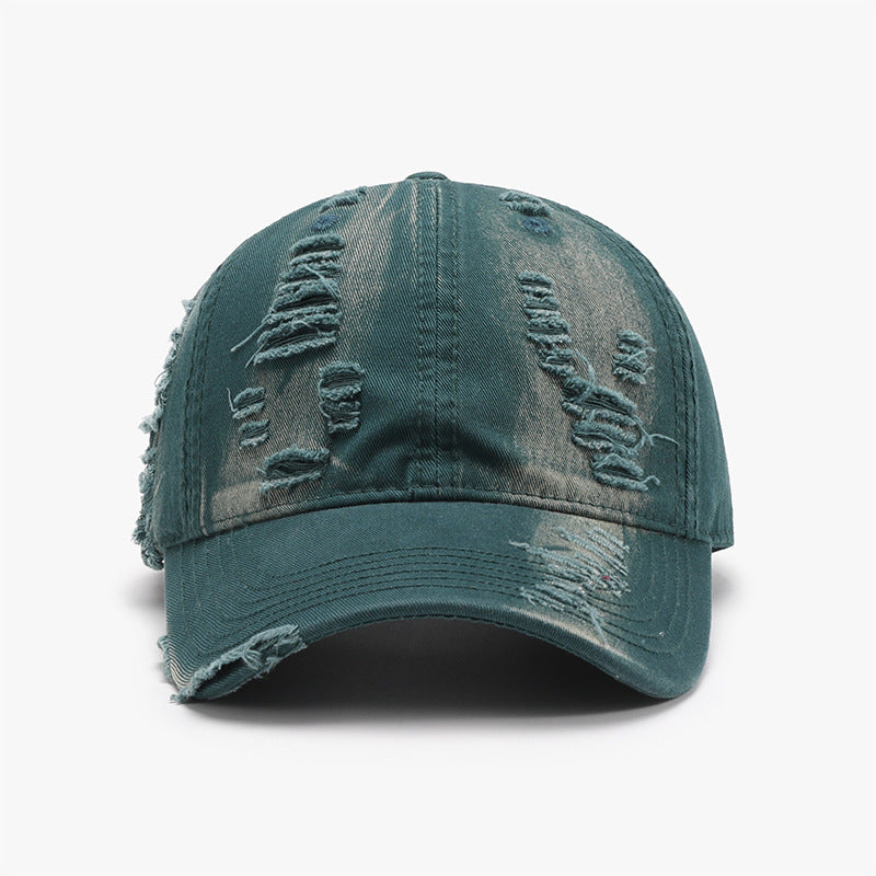 Distressed blue-green cotton baseball cap with a six-panel crown, curved brim, tonal stitching, and frayed details across the crown and visor.