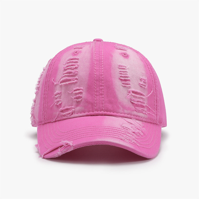 Bright pink distressed cotton baseball cap with a classic six-panel crown, gently curved brim, tonal stitching, and frayed details for a worn-in look.