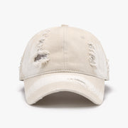 Cream distressed cotton baseball cap with a structured six-panel crown, frayed accents, stitched seams, and a curved brim.
