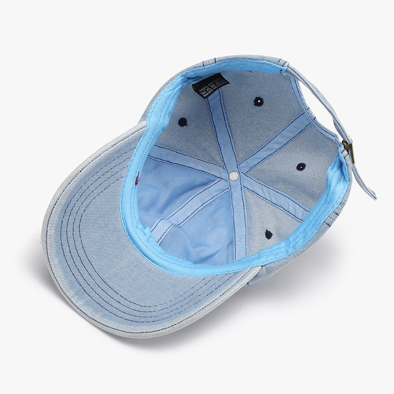 Light blue distressed cotton baseball cap shown from below, featuring a curved brim, six-panel construction, ventilation eyelets, and an adjustable back strap.