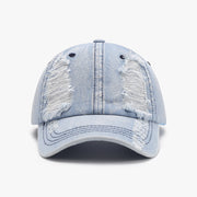 Light-wash distressed cotton baseball cap with a structured six-panel crown, visible seam lines, ventilation eyelets, frayed detailing, and a curved brim.