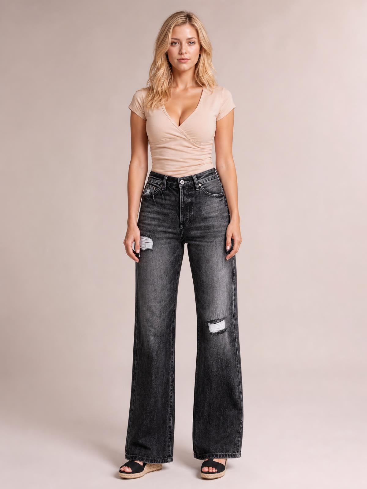 Model standing front-facing in dark gray distressed straight leg jeans with a high waist, belt loops, five-pocket construction, and ripped knees.