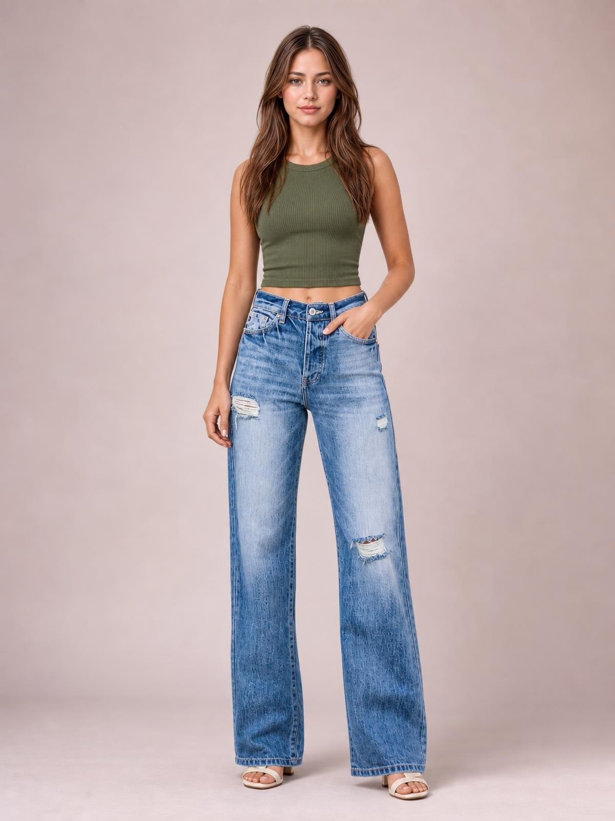 Model stands facing forward in light blue distressed straight-leg jeans with a high waist, belt loops, front pockets, and relaxed full-length silhouette.