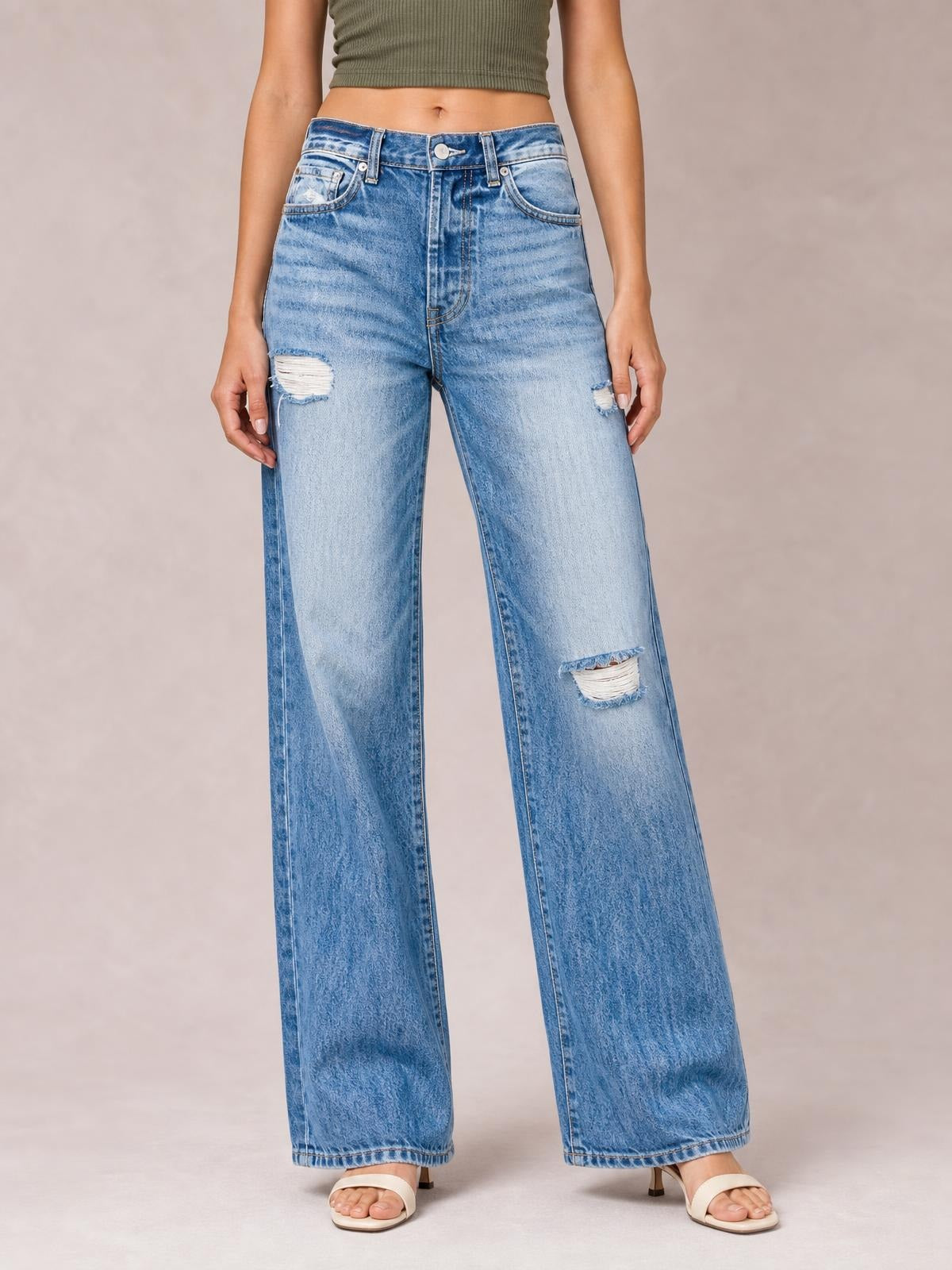 A model stands in light-blue distressed straight-leg jeans with a high-rise waist, five-pocket construction, button fly, and ripped knees and thigh.