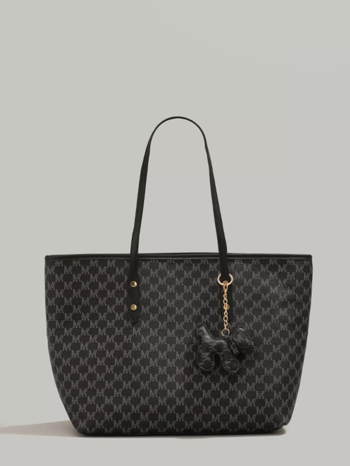 Large black PU leather tote bag with a repeating monogram-style pattern, double shoulder handles, gold-tone hardware, and a dangling dog charm.