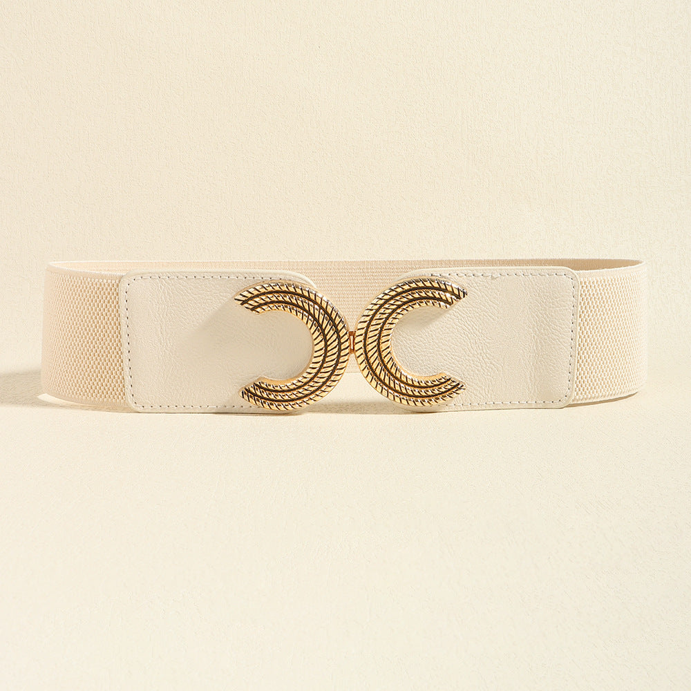 A cream elastic waist belt features a wide structured band, stitched PU panels, and a sculptural gold-tone double C buckle.