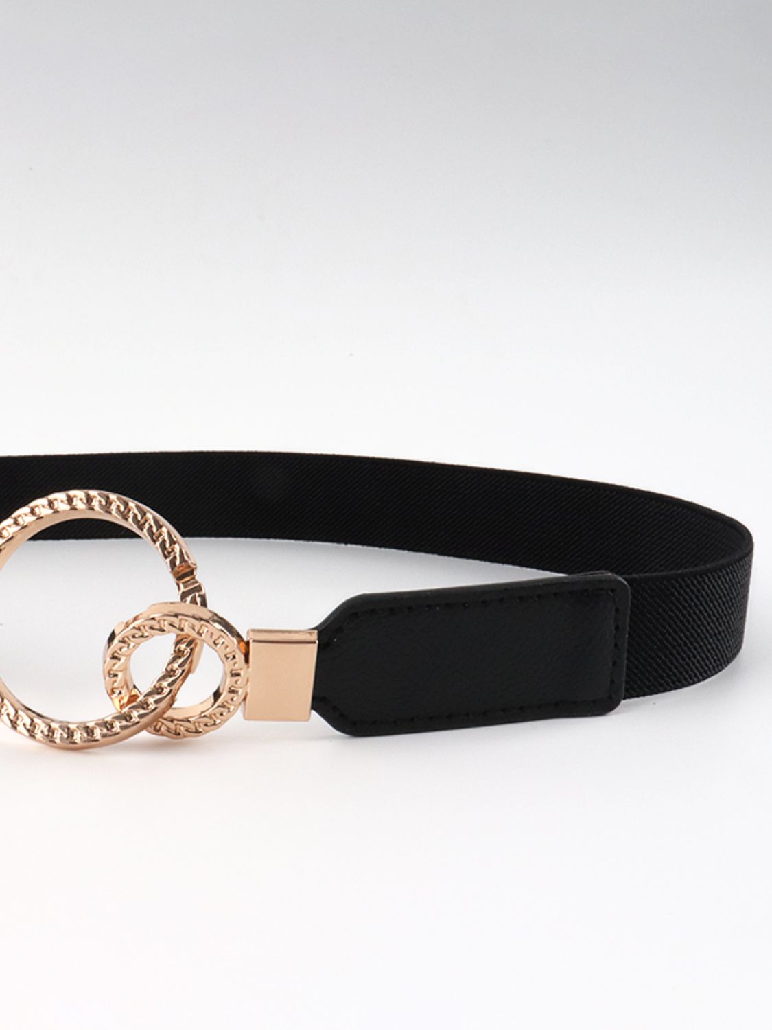 Black elastic PU belt featuring a wide streamlined band, stitched tab, and distinctive double-ring gold-tone alloy buckle.