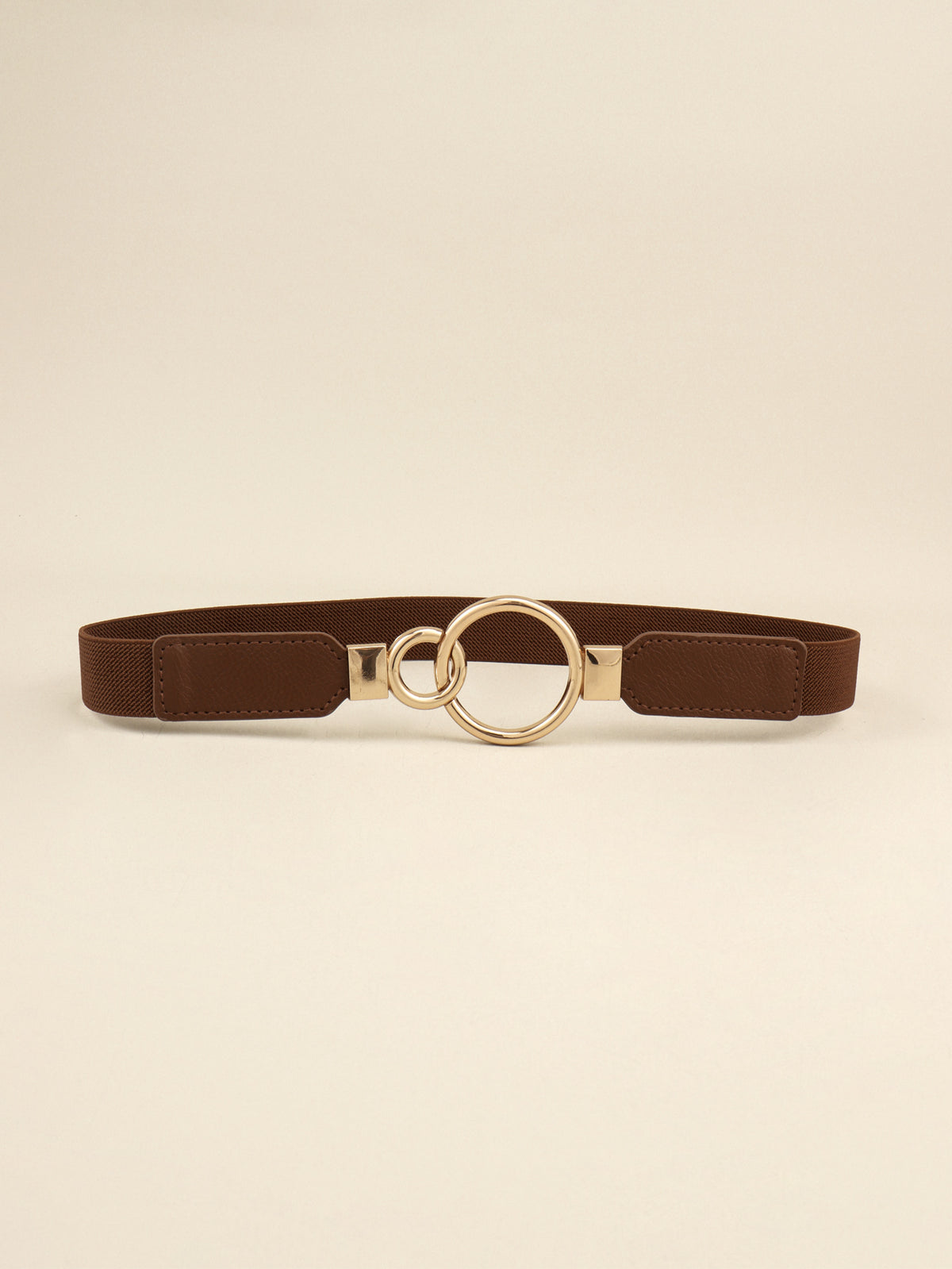 Brown elastic PU belt with stitched side panels and a distinctive gold-tone double-ring alloy buckle in a streamlined 1-inch silhouette.