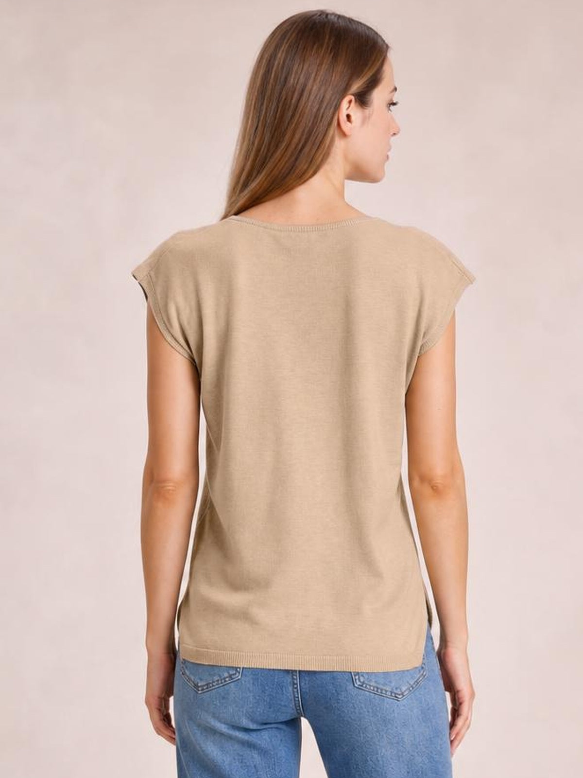 A model shows the back of a beige knit top with cap sleeves, a ribbed round neckline and hem, and a relaxed straight silhouette.