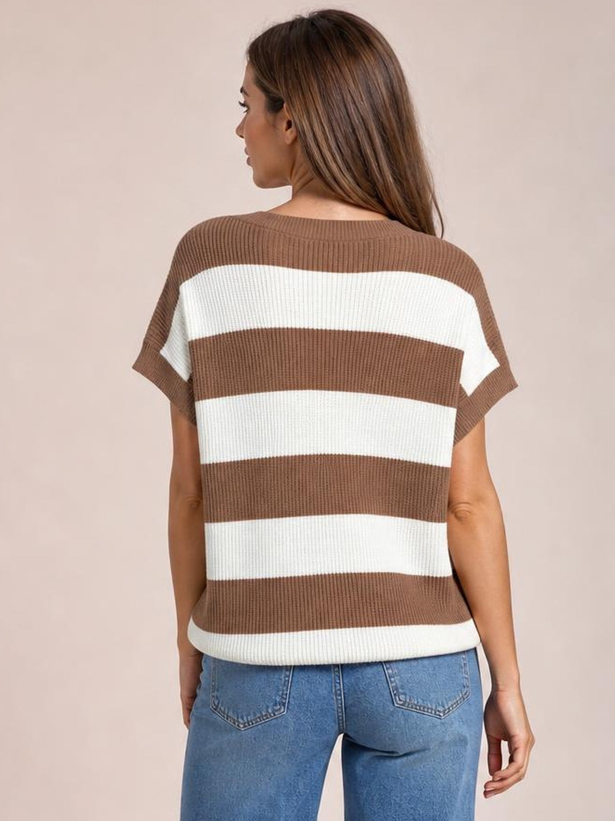 Model shown from the back wears a brown and white striped short-sleeve sweater with a relaxed silhouette, ribbed construction, and a gently curved hem.