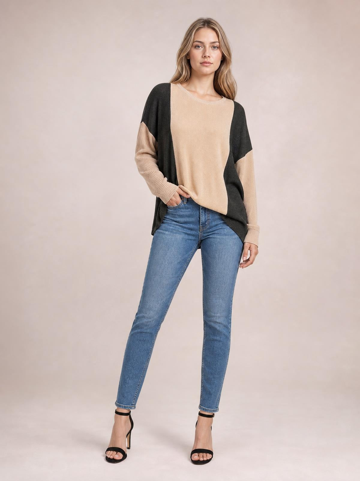 Model stands in a relaxed pose wearing a beige and charcoal texture contrast round neck long sleeve T-shirt with a loose silhouette and ribbed construction.