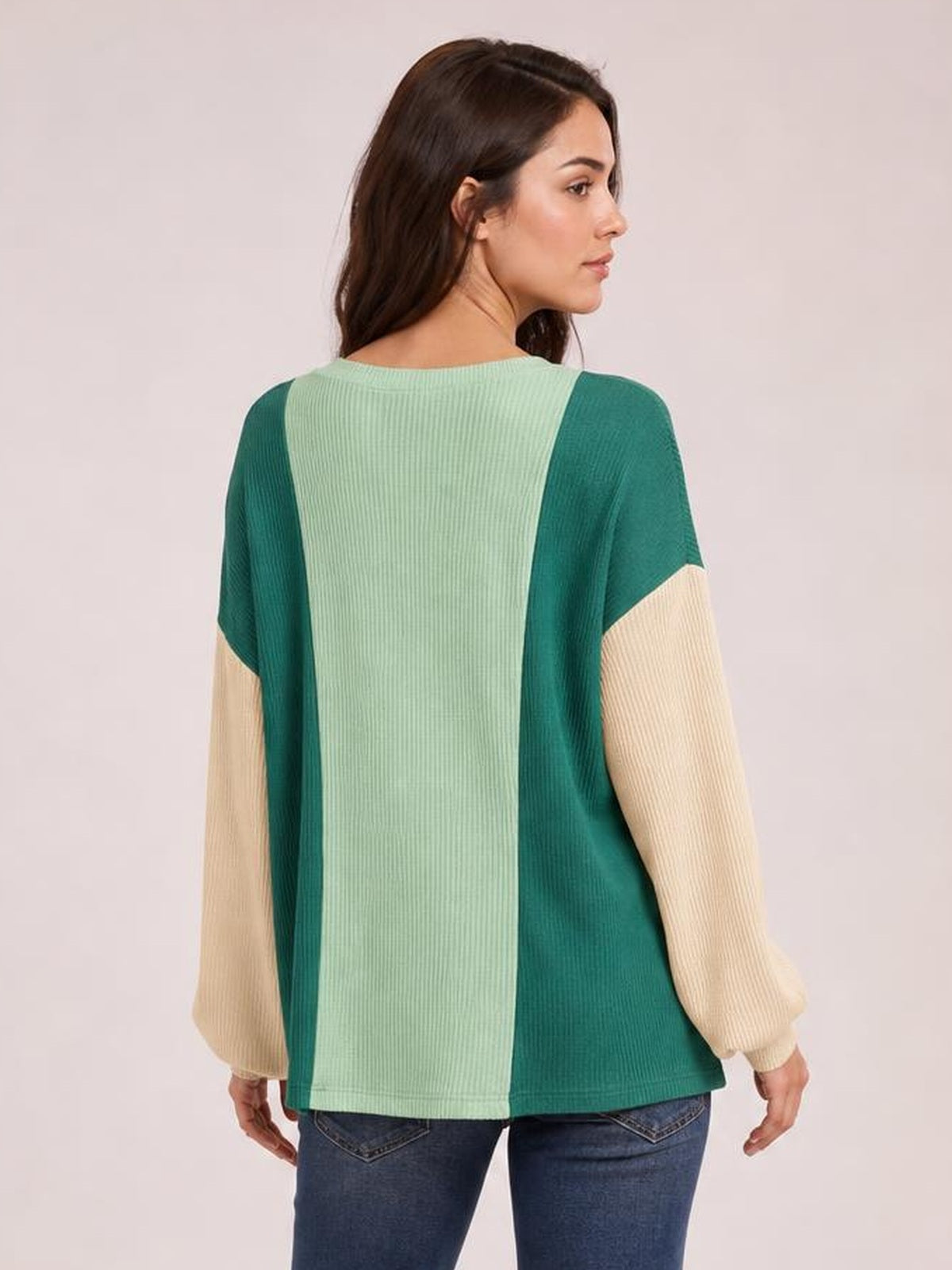 Model shown from the back in a relaxed stance wearing a color-blocked texture contrast round neck long sleeve T-shirt in teal, mint green, and cream.