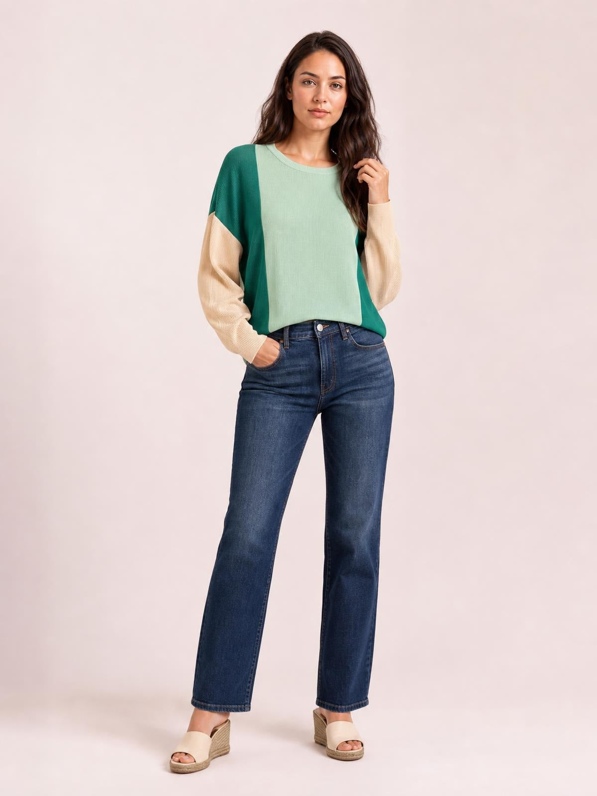 A model poses in a relaxed texture contrast round neck long sleeve T-shirt with a mint green, teal, and cream color-blocked silhouette.