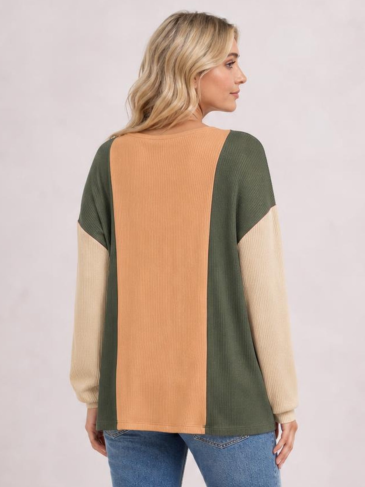 Model shown from behind wearing a relaxed texture contrast long sleeve T-shirt with an olive, tan, and rust color-blocked silhouette.