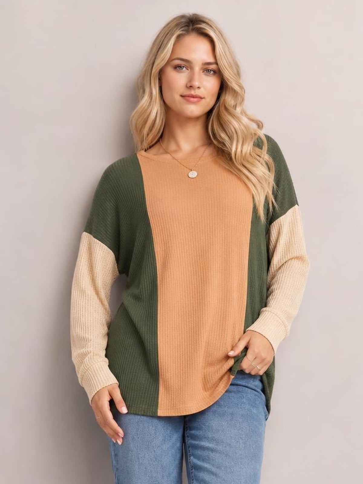 Model wears a textured contrast long-sleeve T-shirt with a camel ribbed front, olive-green side panels, cream sleeves, a round neck, and relaxed silhouette.
