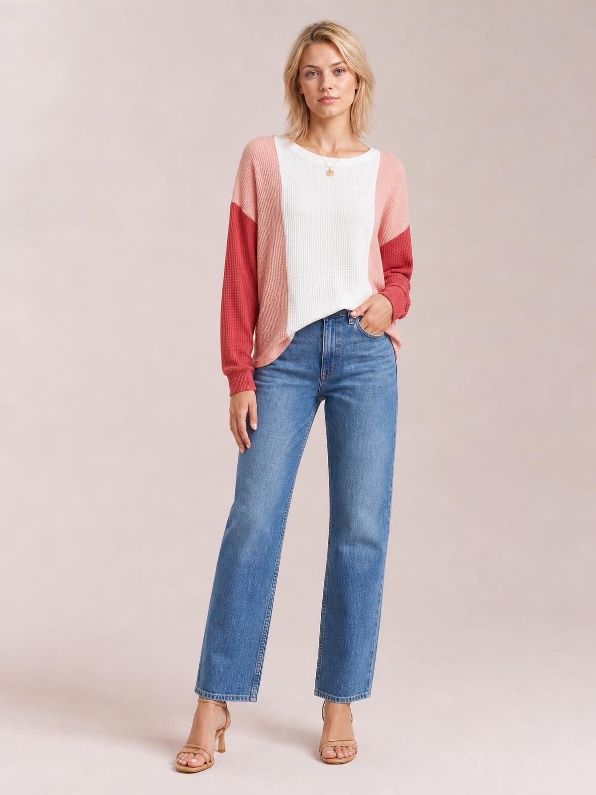 Model wears a relaxed texture contrast long sleeve T-shirt with a round neck, white center, pink panels, and darker pink sleeve sections.