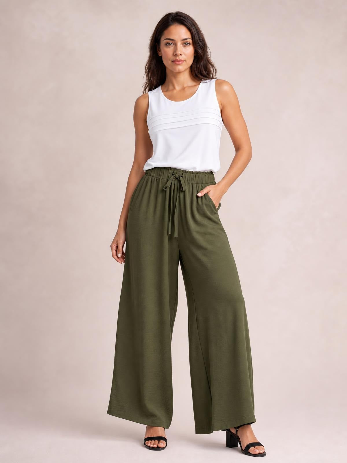 A model stands in olive-green drawstring wide-leg pants with an elastic waistband, relaxed silhouette, side pockets, and straight full-length hems.
