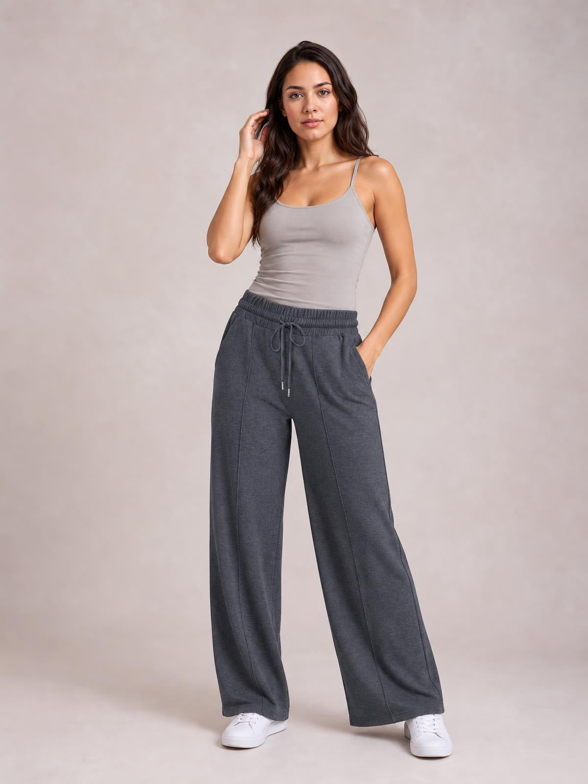 Model wearing charcoal drawstring elastic waist wide leg pants with a relaxed flowing silhouette, front pockets, and straight seam detailing.