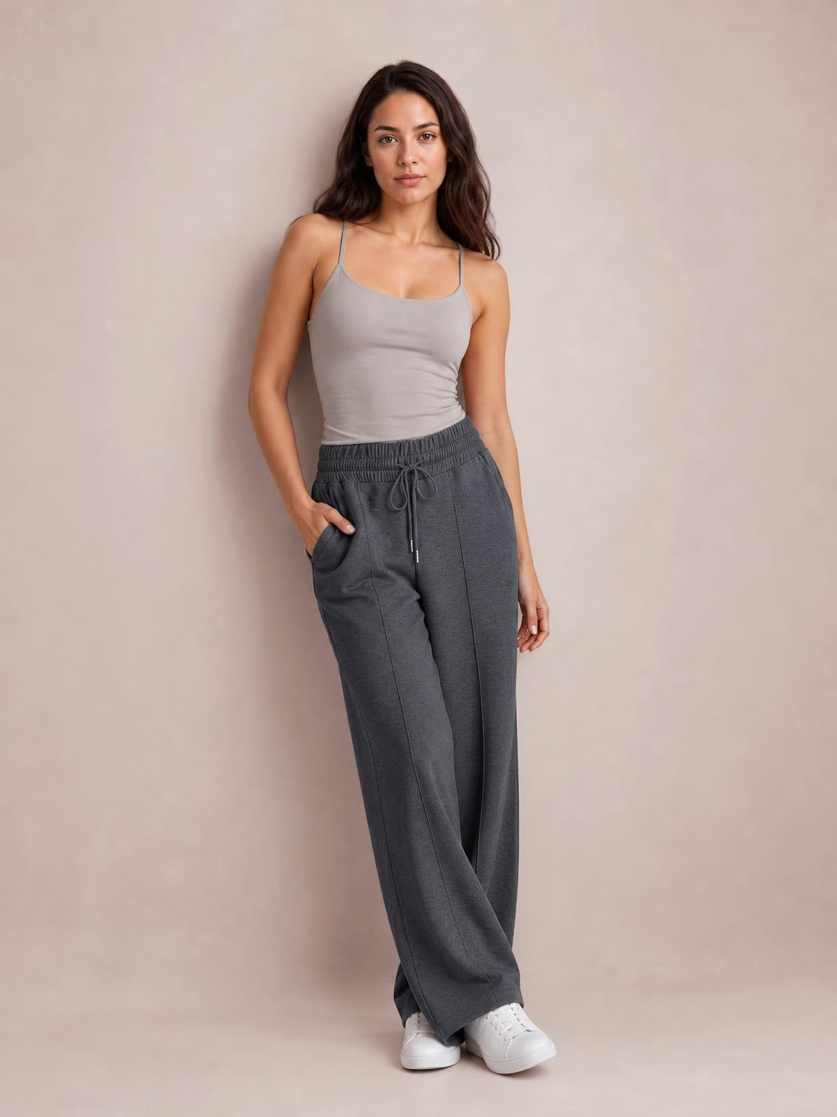 Model poses in charcoal gray drawstring elastic waist wide leg pants with a relaxed silhouette, front pockets, and full-length construction.