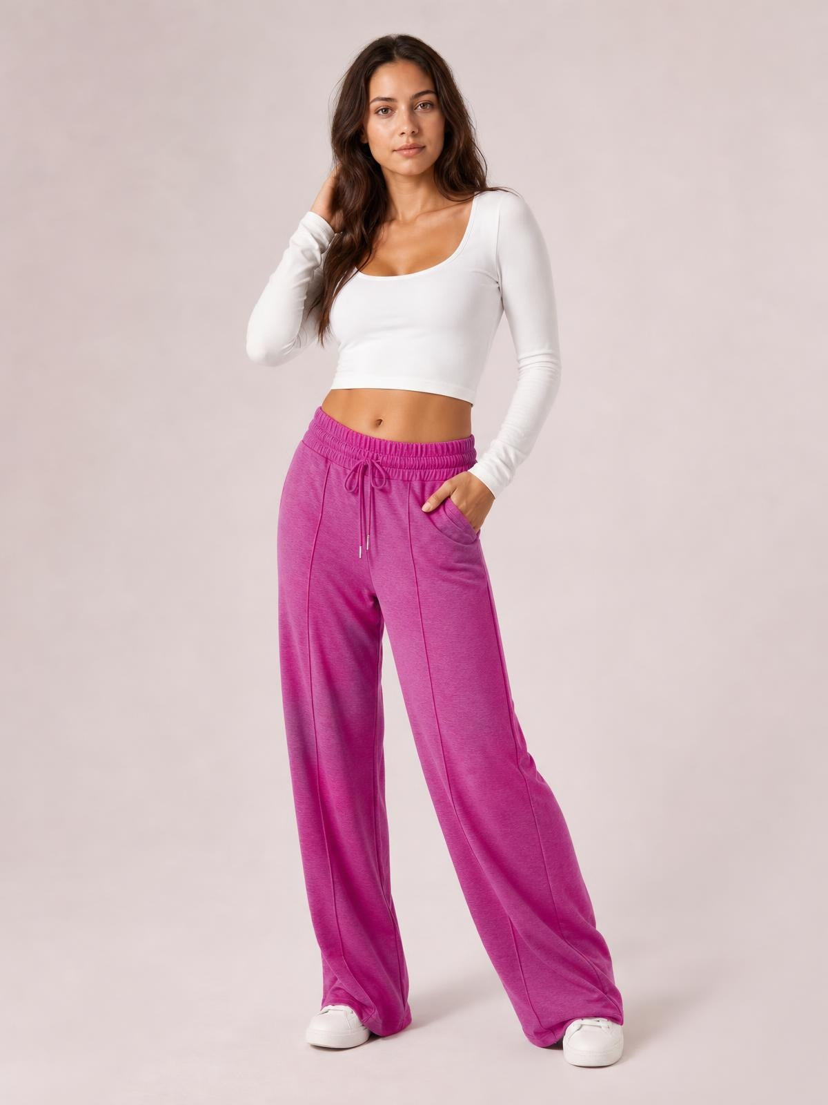 Model poses in bright magenta drawstring elastic waist wide leg pants with front pockets, relaxed drape, and a hand tucked into one pocket.