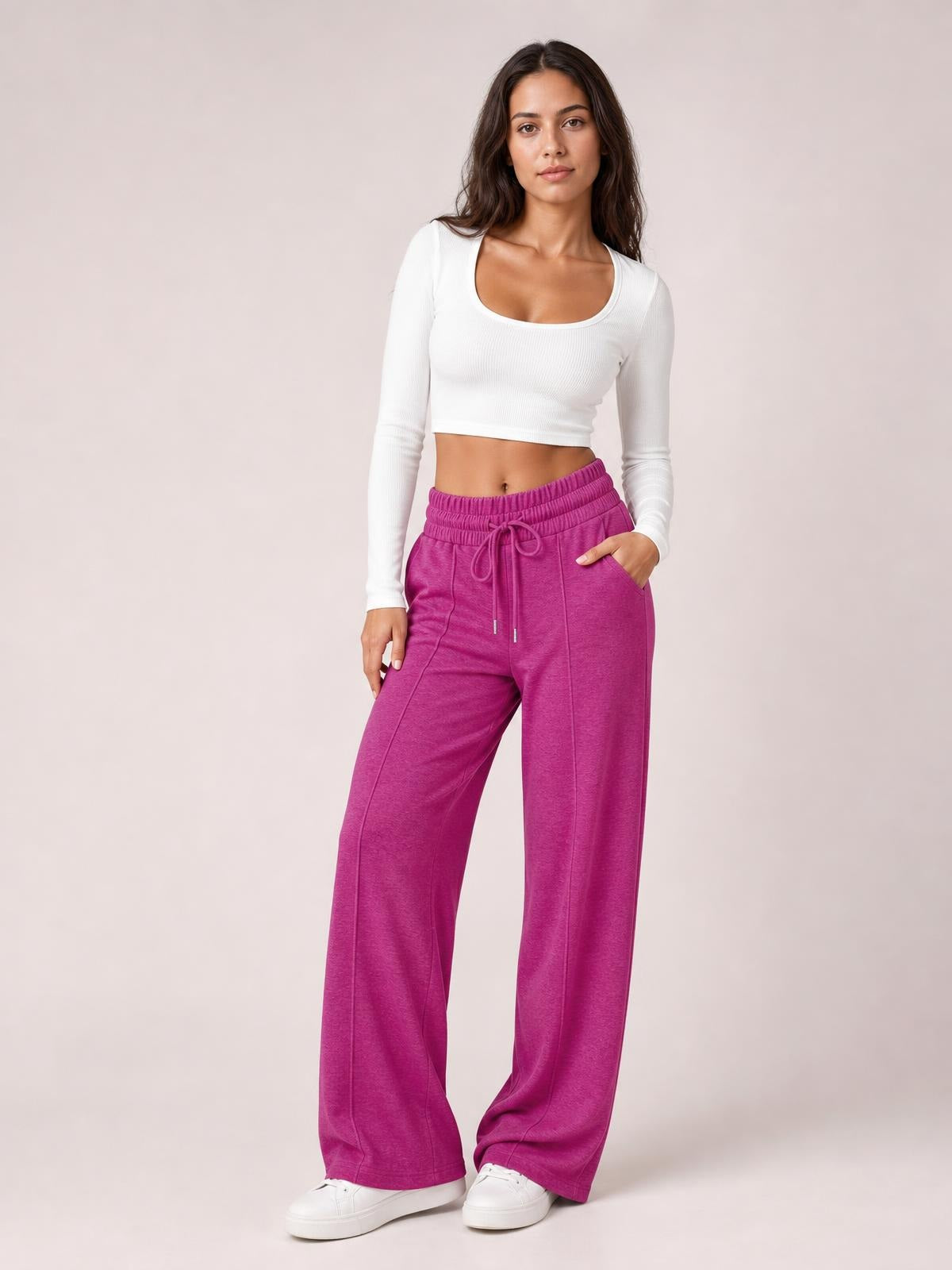 Model wears magenta drawstring elastic waist wide-leg pants with a relaxed flowy silhouette, front pockets, and visible stitched leg seams.