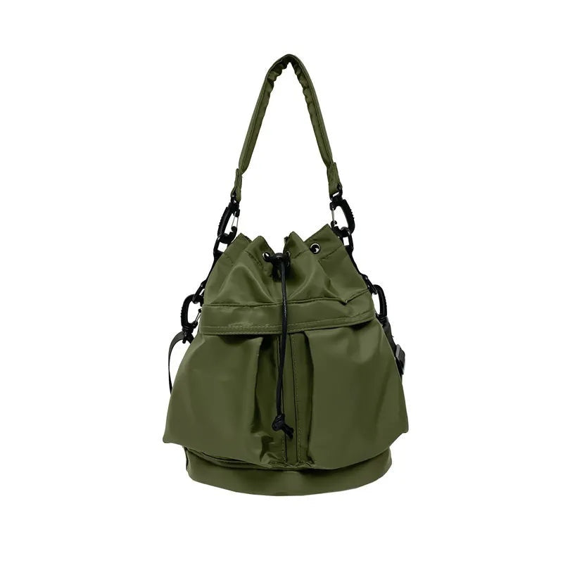 Olive green nylon bucket bag with a softly gathered drawstring opening, structured rounded base, top handle, and adjustable side straps with black hardware.