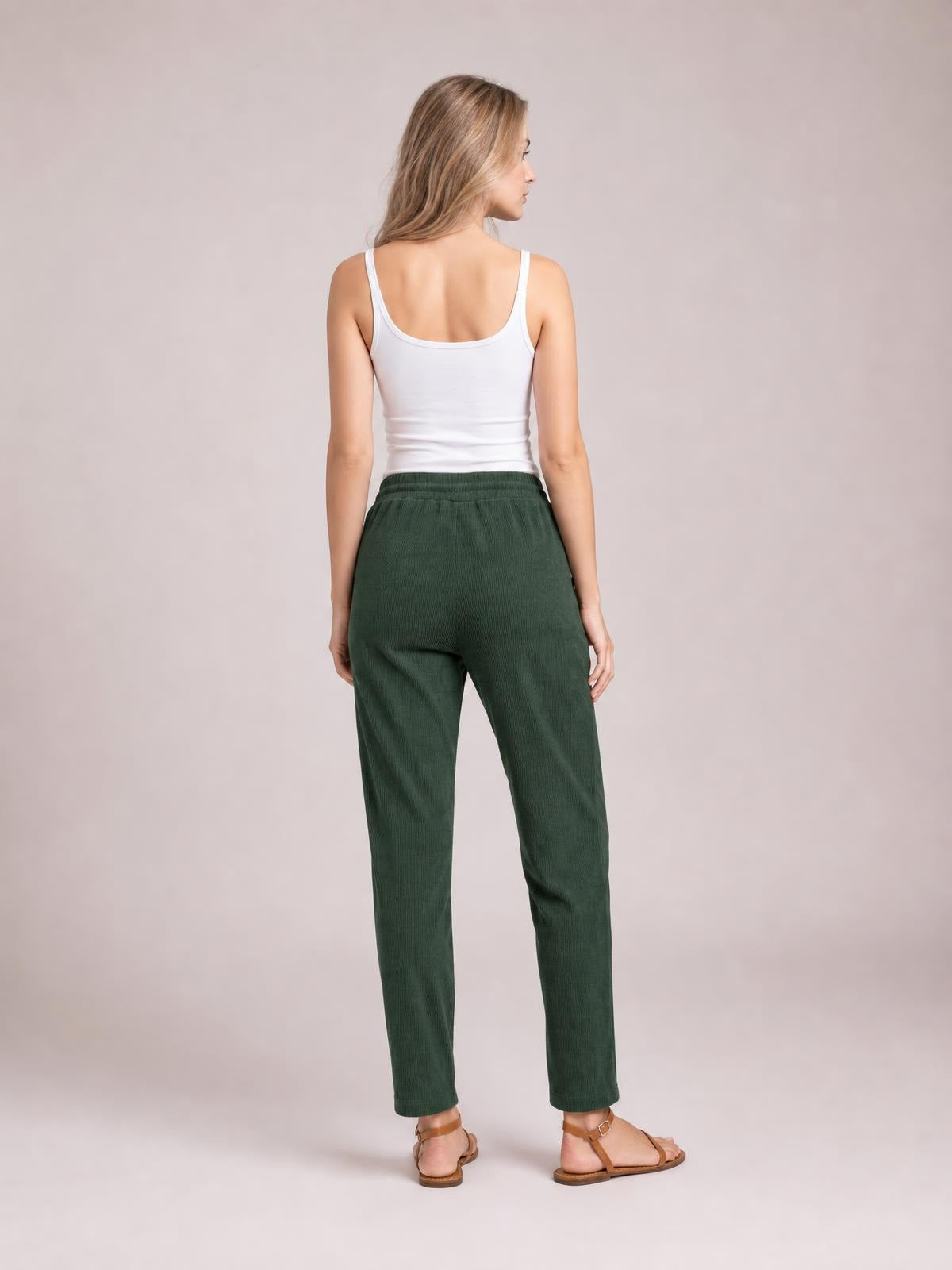 Model shown from behind wearing dark green drawstring straight pants with an elastic waist, relaxed fit, and full-length tapered legs.