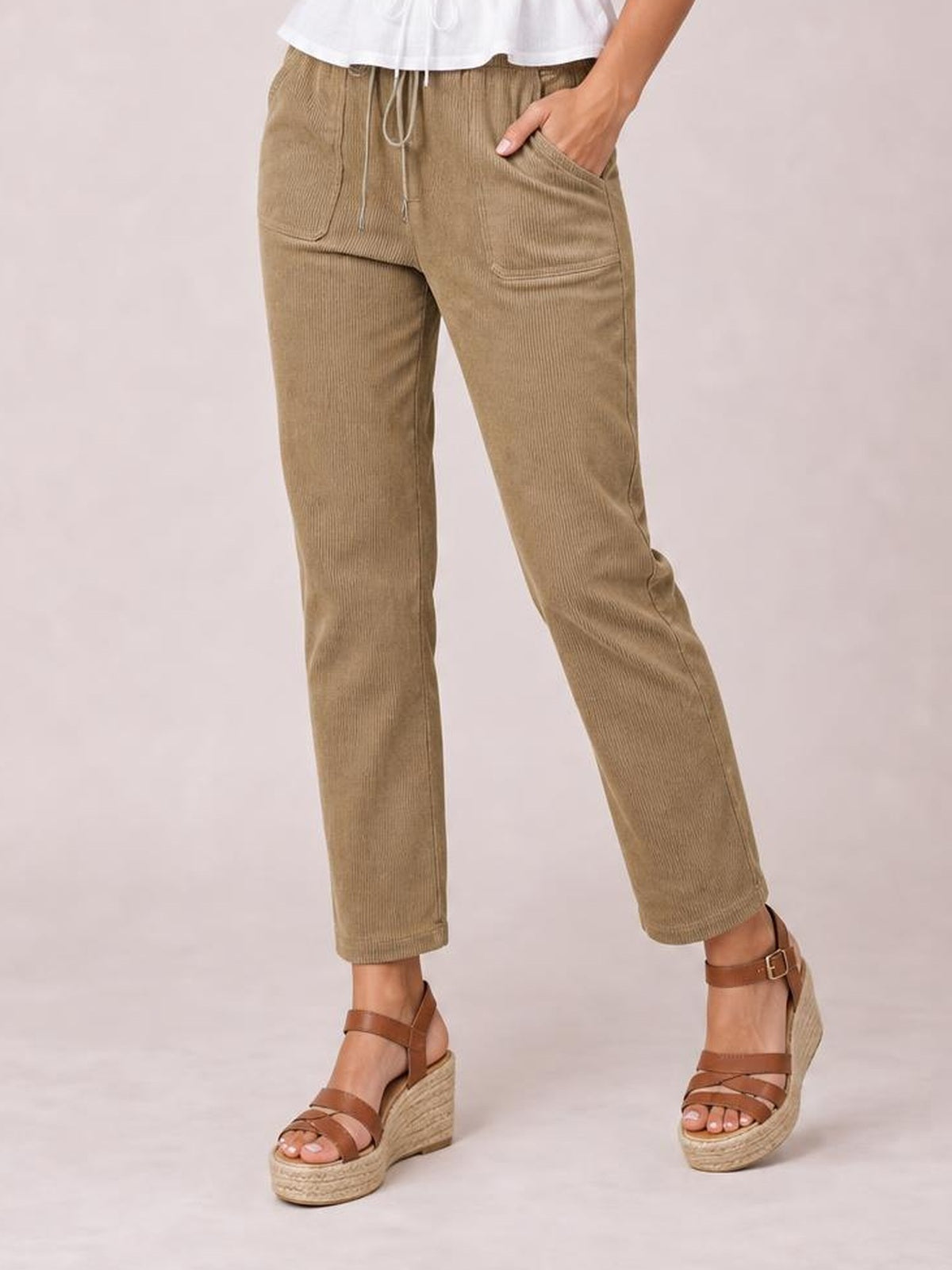 Model wearing khaki drawstring straight pants with visible front pockets, a relaxed mid-rise fit, and cropped straight-leg silhouette.