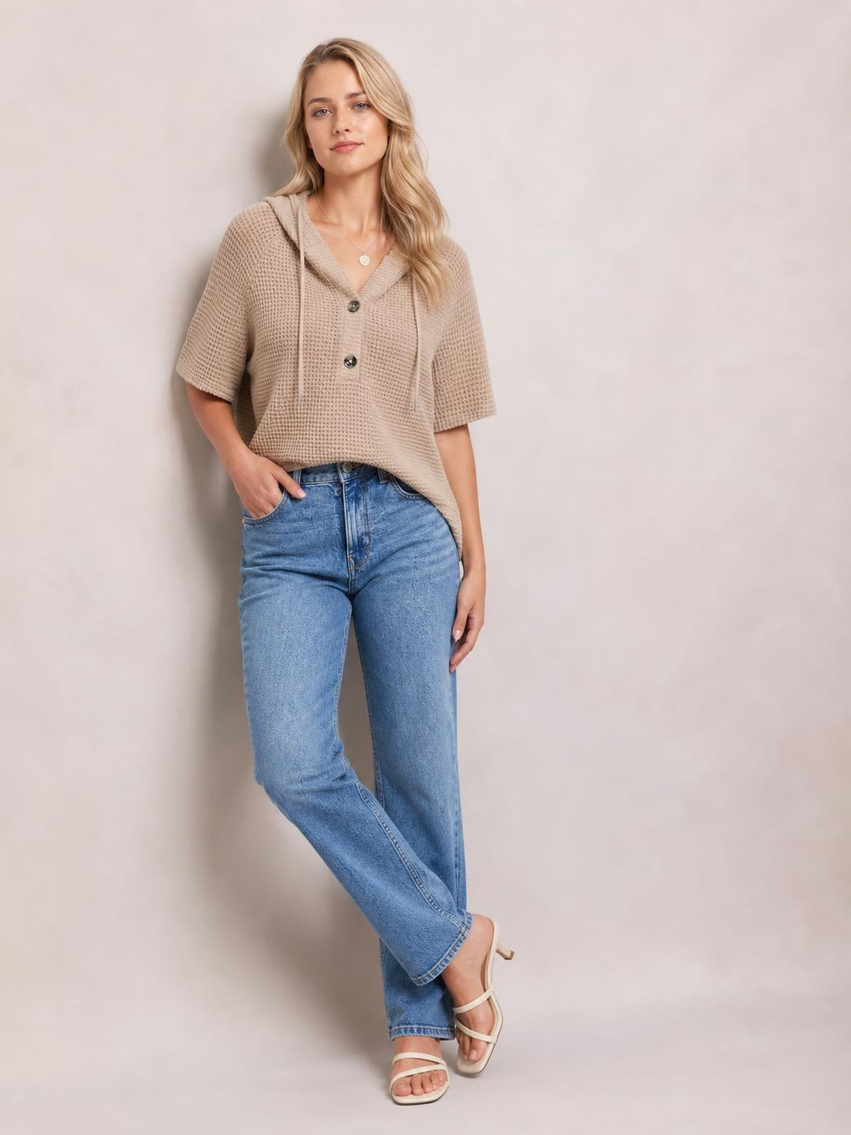 Model wears a taupe waffle-knit short-sleeve hooded top with drawstring detail, buttoned front, relaxed silhouette, and slight stretch.