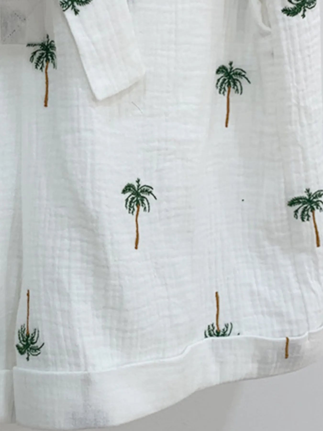 Palm Tree Print Short Sleeve Button-Up Romper with Belt and Pockets.