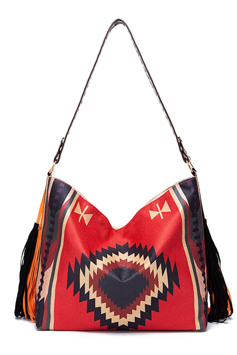Oversized geometric canvas tote bag in red, black, and cream with a roomy rectangular silhouette, long shoulder strap, and fringe detailing along the sides.