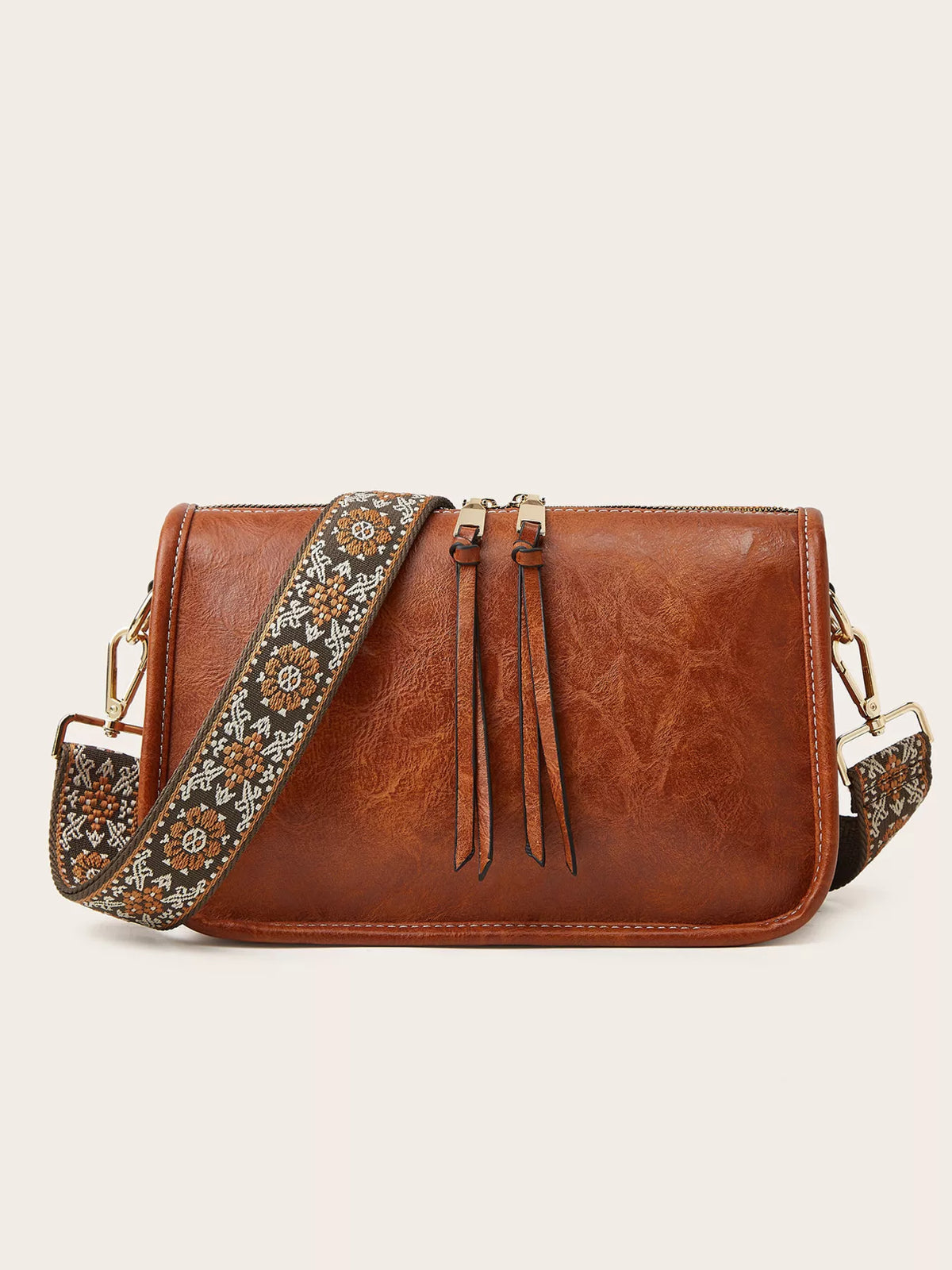 Vintage-style small brown PU leather crossbody bag with a rectangular silhouette, gold-tone hardware, and a wide floral-patterned strap.